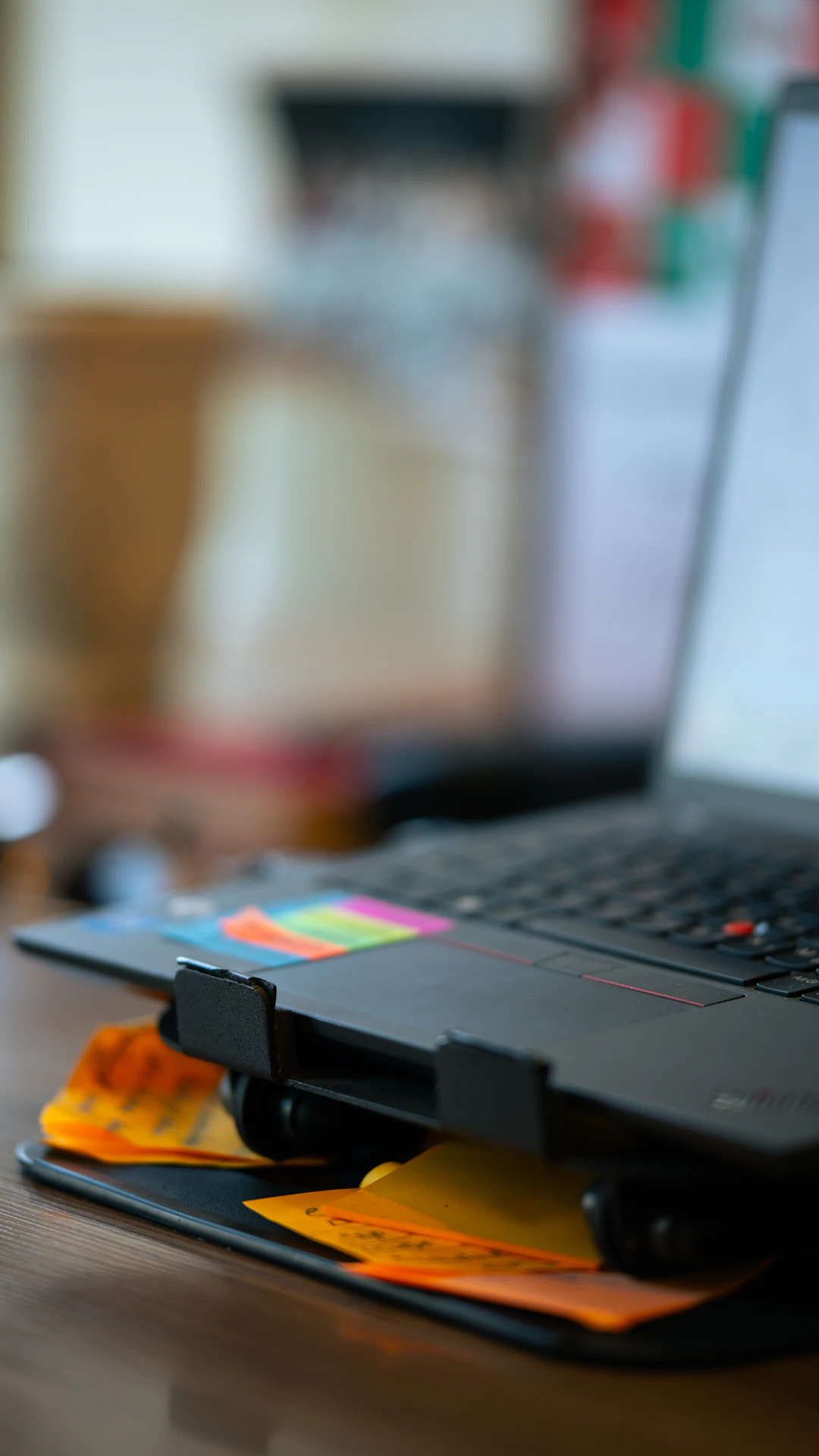 A laptop computer sitting on top of a wooden table