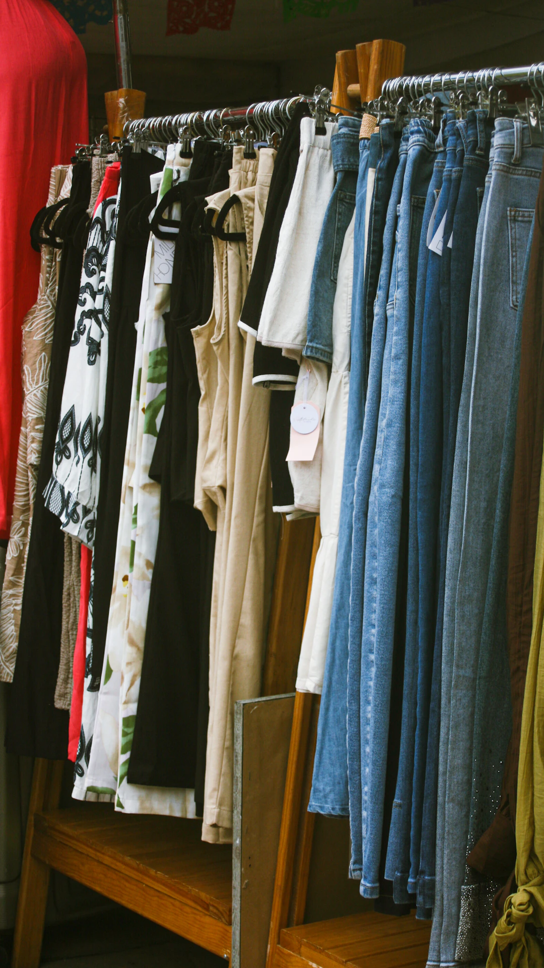Assortment of clothing items hanging on a rack.