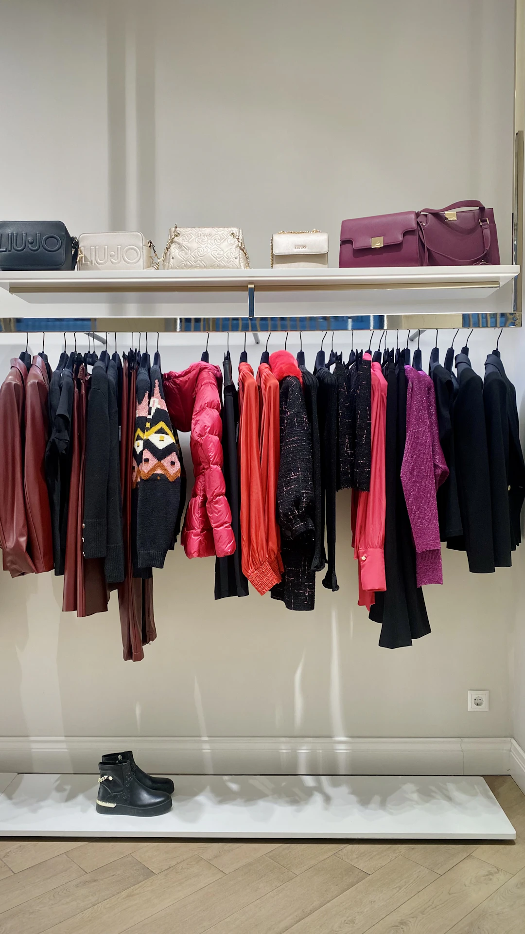 a rack of clothes and shoes in a store
