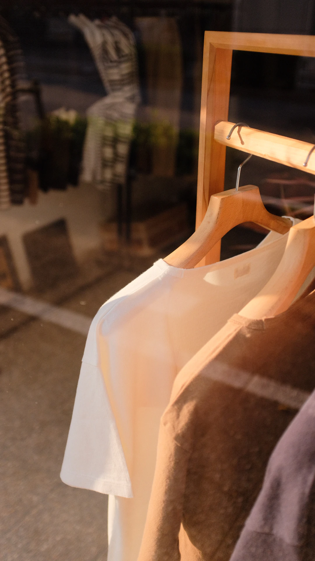 white scoop neck shirt on brown wooden clothes hanger
