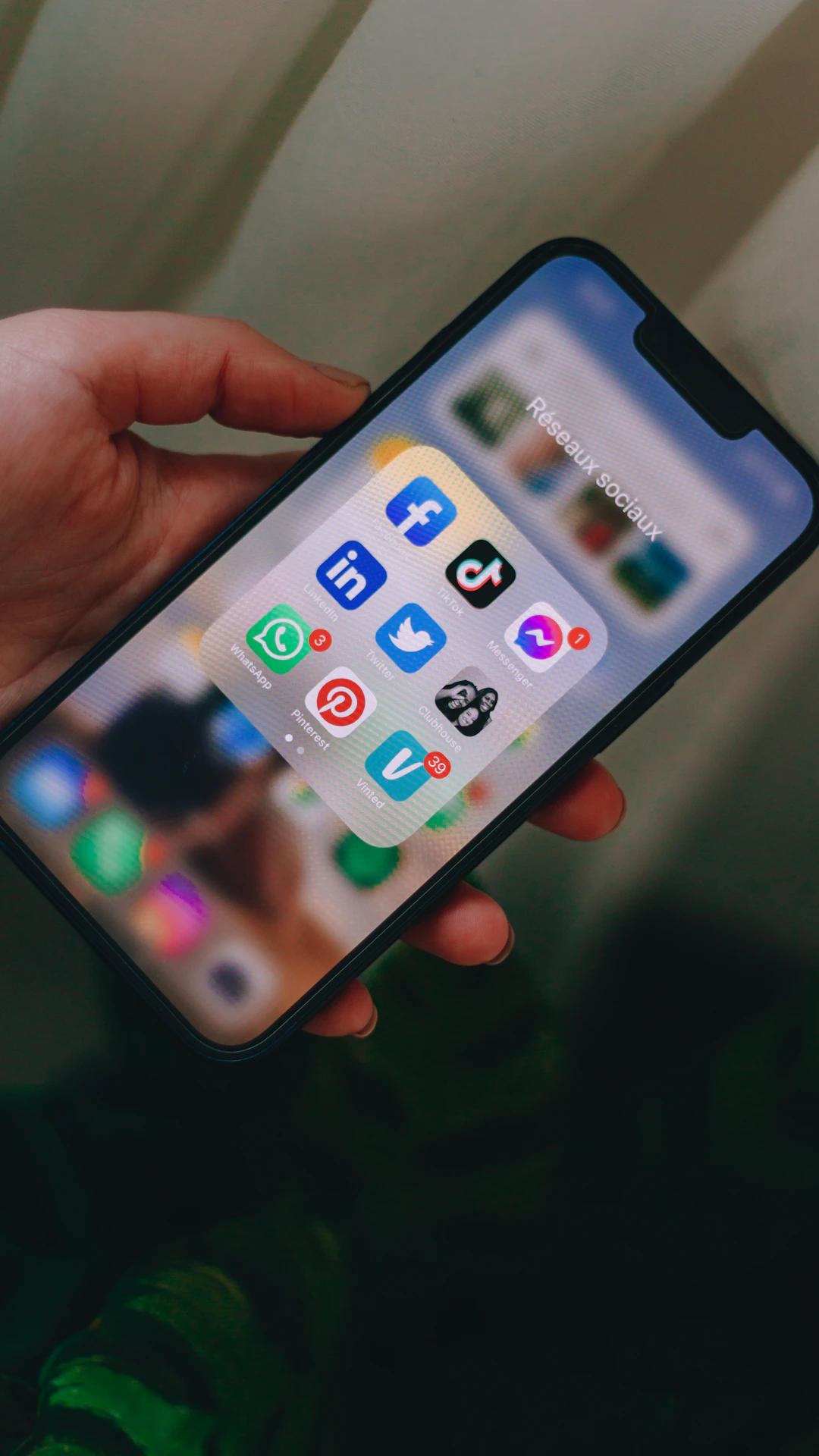 a person holding a cell phone in their hand