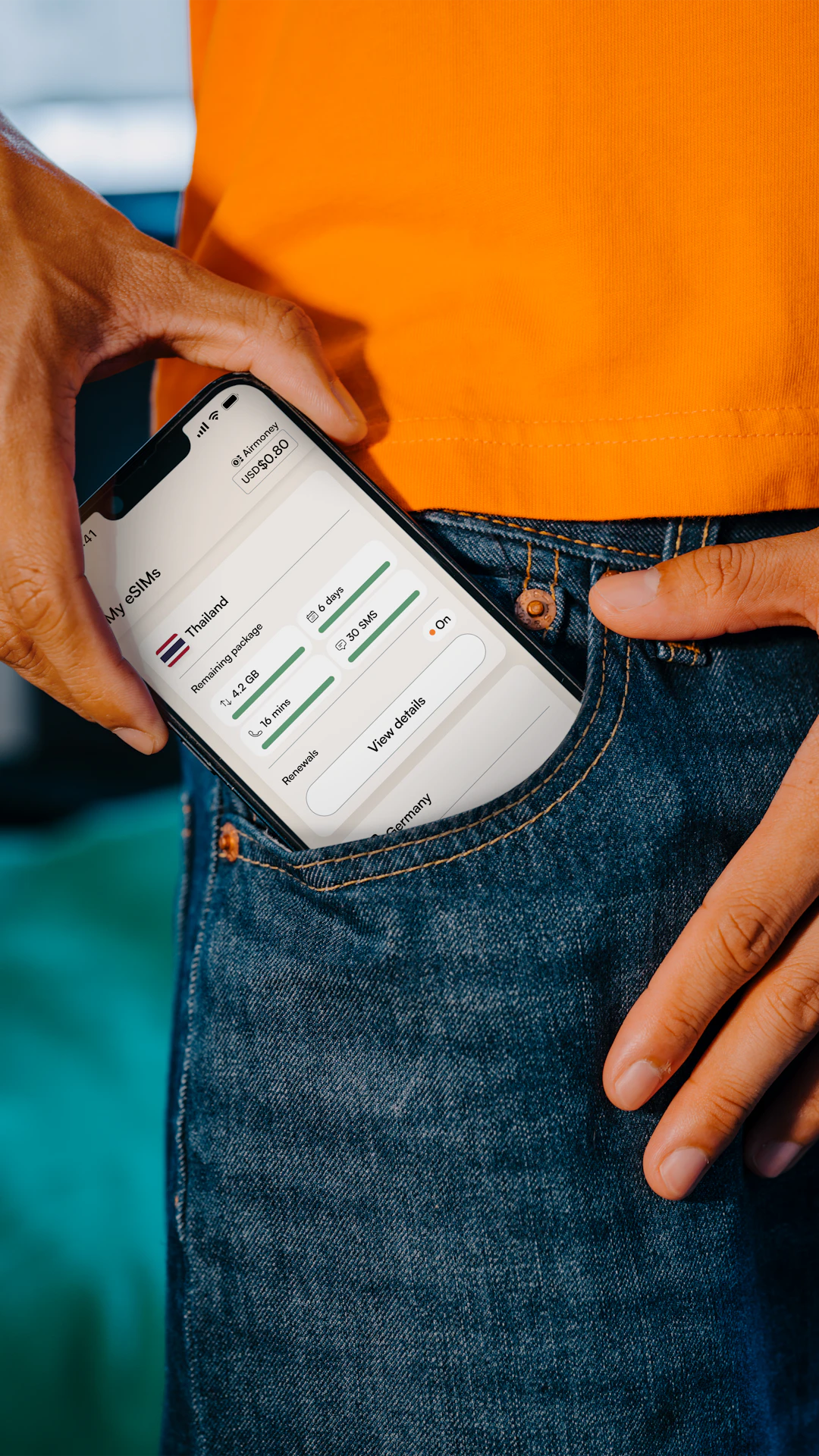 Smartphone being placed in a jeans pocket