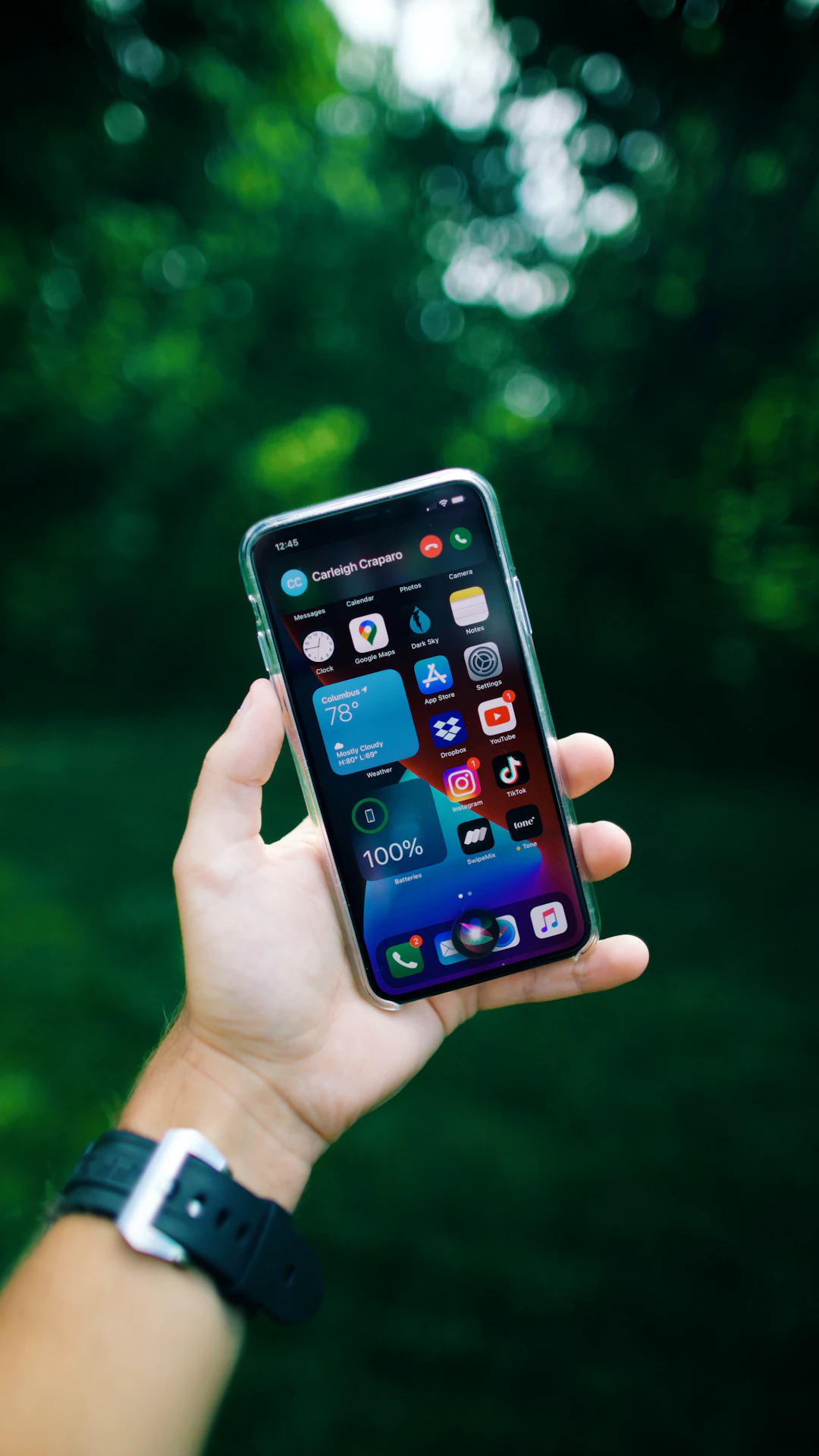 person holding black iphone 4
