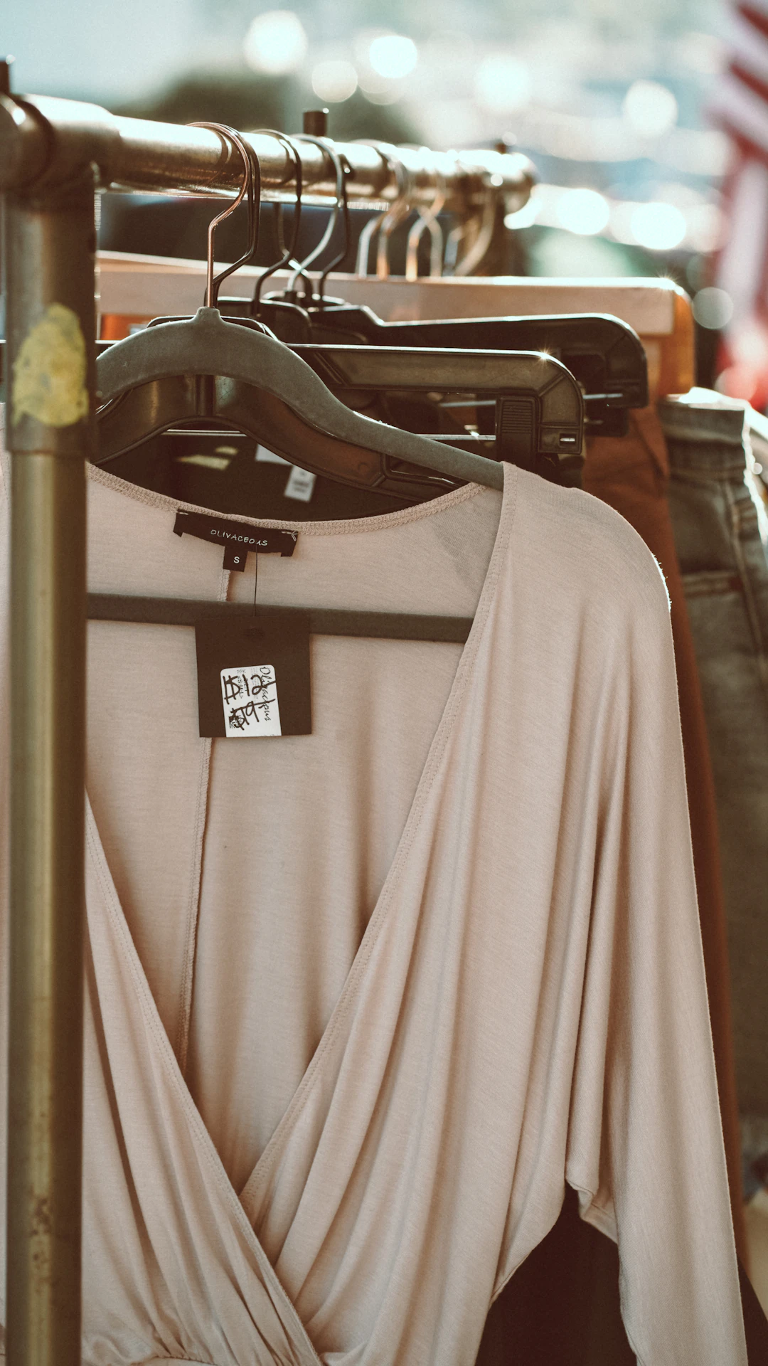 gray long sleeve shirt hanging on black clothes hanger