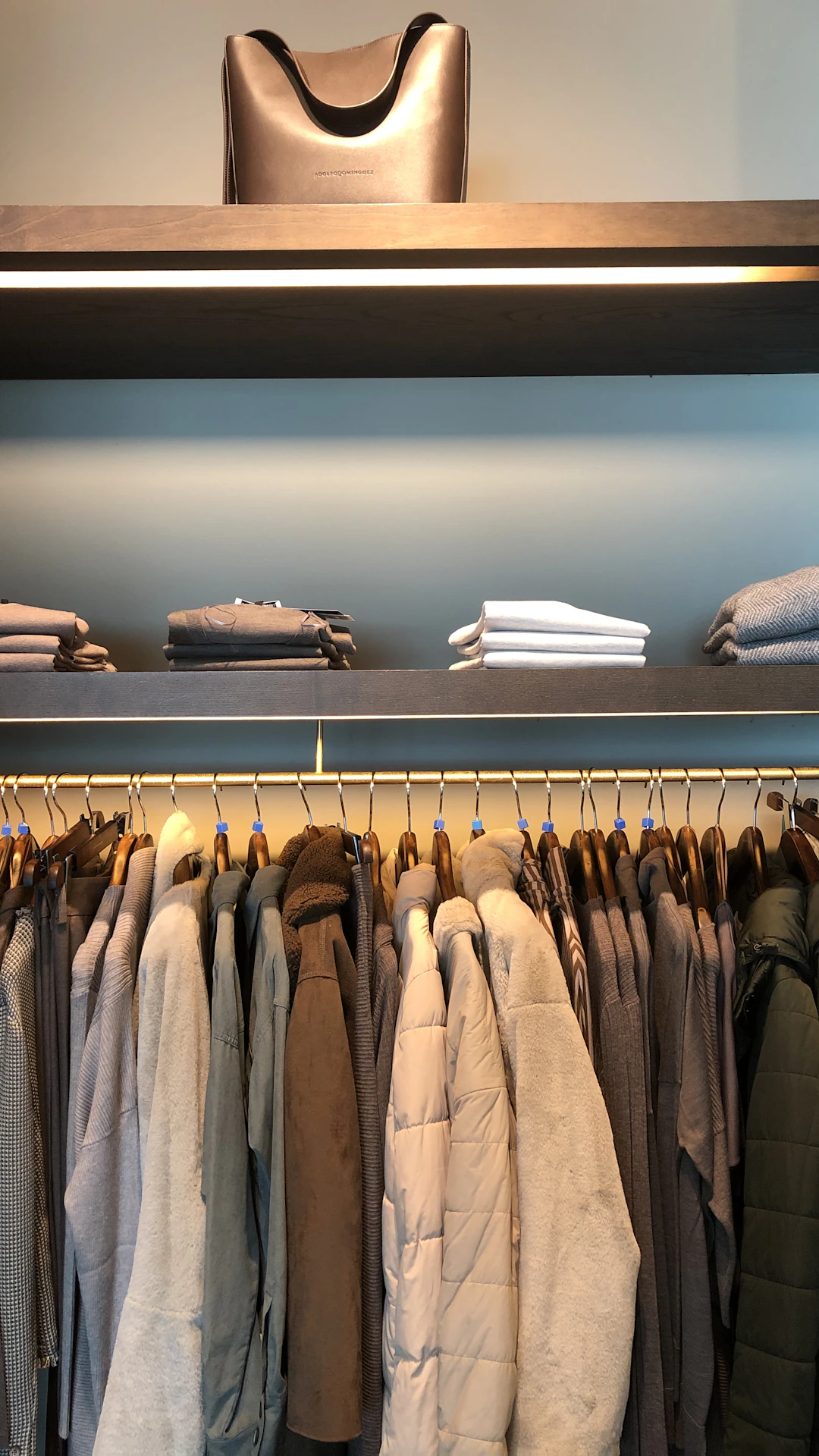 folded clothes above hanged clothes