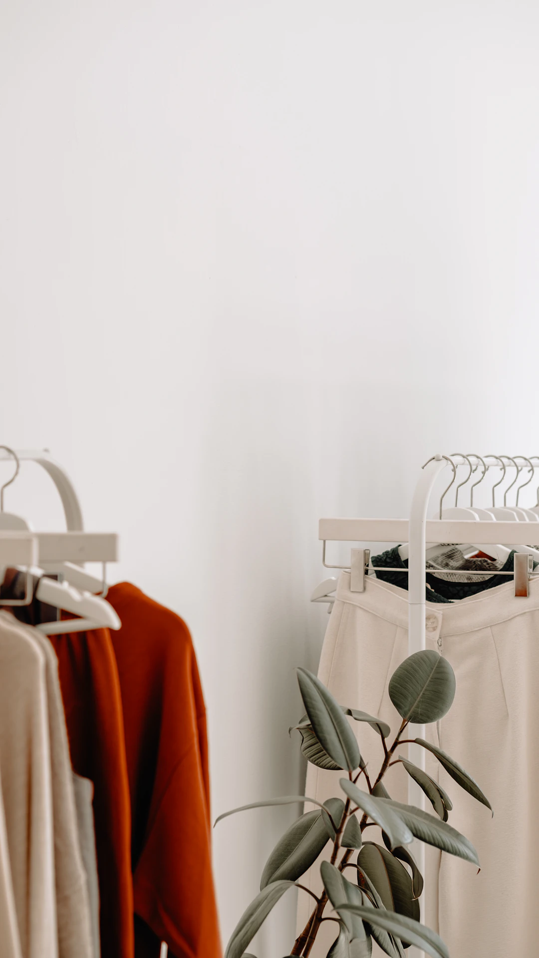 clothing racks with neutral toned garments