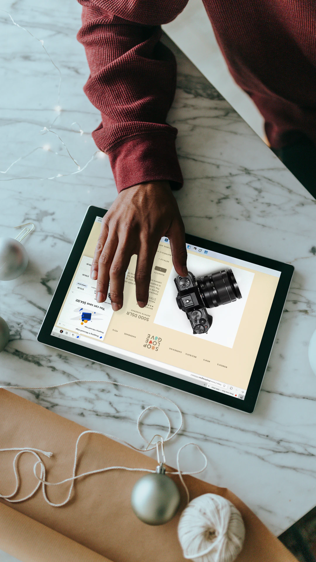 Overhead view of a person clicking on a Surface laptop with wrapping presents around